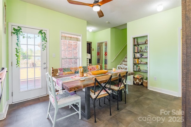 dining room with stairway, baseboards, and ceiling fan