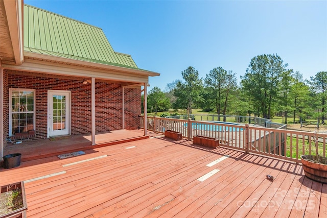 deck with a fenced in pool and fence