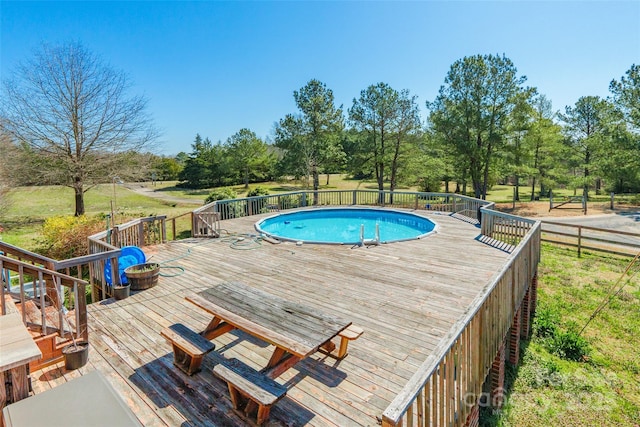 view of swimming pool featuring a fenced in pool and a deck