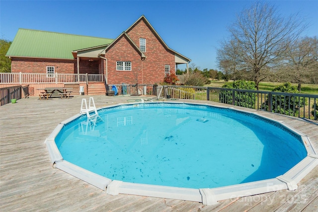 view of pool featuring a wooden deck and a fenced in pool