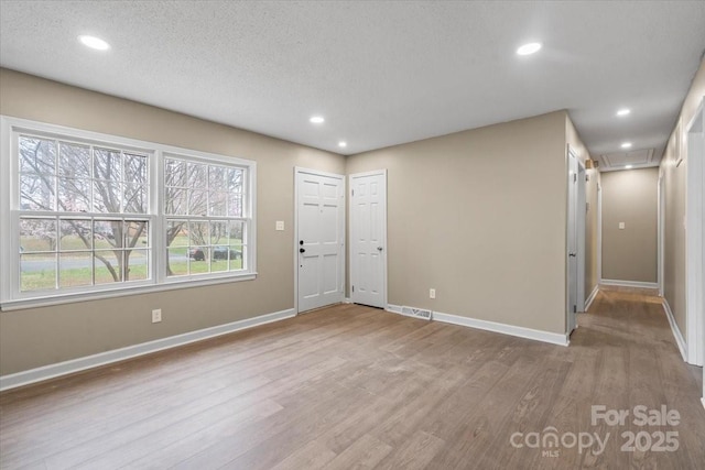 entryway featuring recessed lighting, wood finished floors, and baseboards