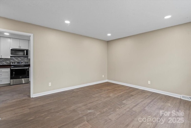 interior space with recessed lighting, baseboards, and wood finished floors