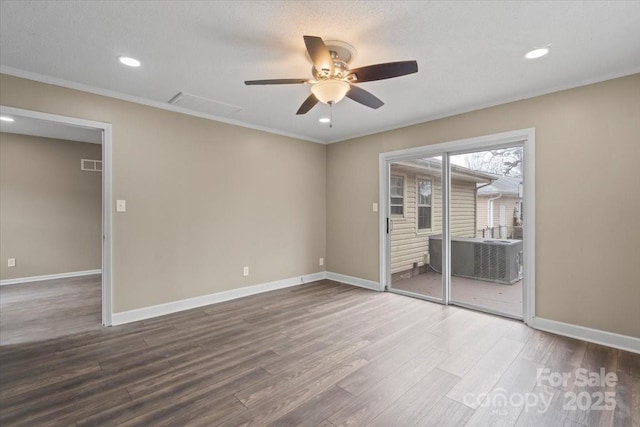 unfurnished room with visible vents, wood finished floors, crown molding, baseboards, and ceiling fan