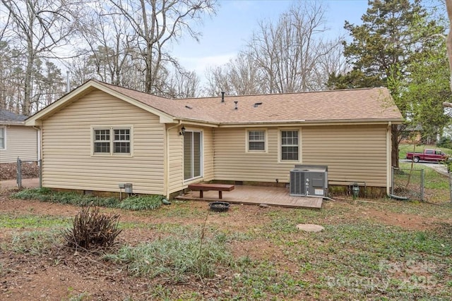 back of house with central AC, fence, a wooden deck, a shingled roof, and crawl space