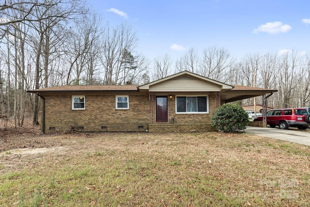 ranch-style house featuring roof with shingles, a front yard, crawl space, a carport, and brick siding