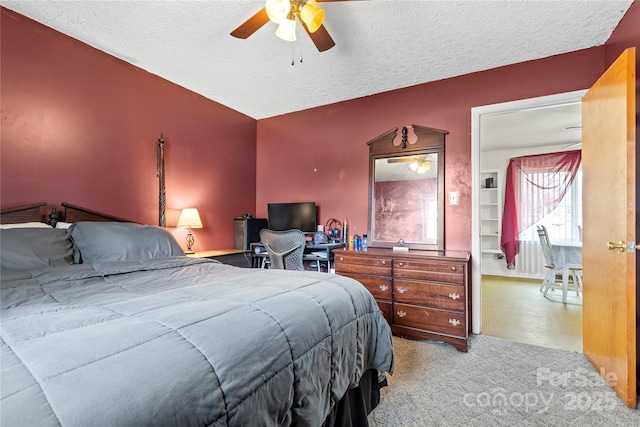 bedroom with carpet flooring, a textured ceiling, and ceiling fan