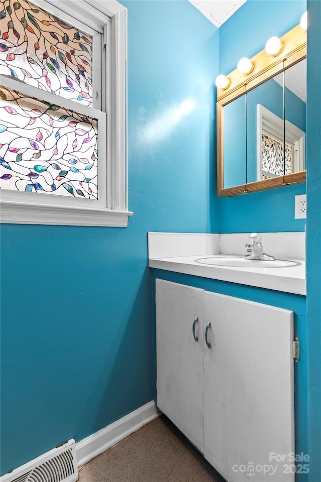 bathroom featuring visible vents, baseboards, speckled floor, and vanity