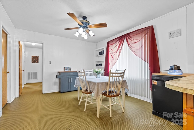 dining space with baseboards, light colored carpet, visible vents, and ceiling fan