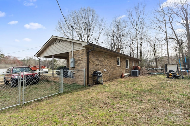 view of property exterior featuring a lawn, fence, cooling unit, a carport, and brick siding