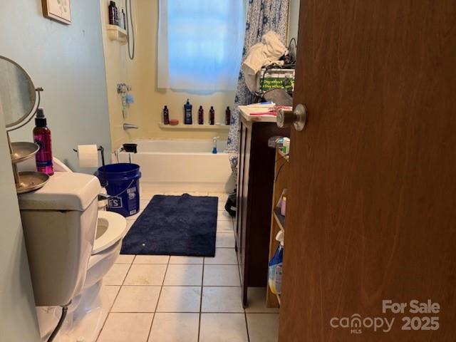 full bathroom featuring tile patterned floors, a shower, toilet, and a tub