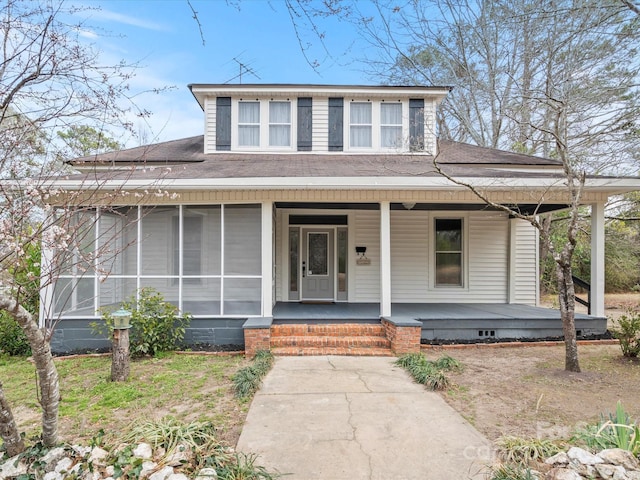 view of front facade featuring a porch and roof with shingles