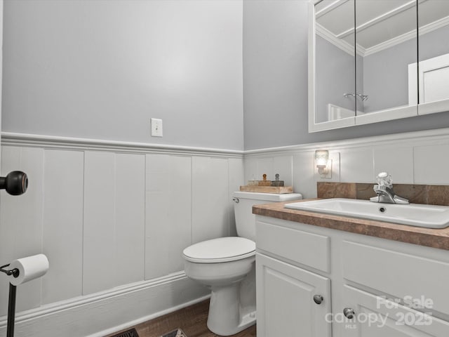 149 Crescent Dr, Chesterfield, SC 29709 - bathroom featuring a wainscoted wall, crown molding, toilet, wood finished floors, and vanity