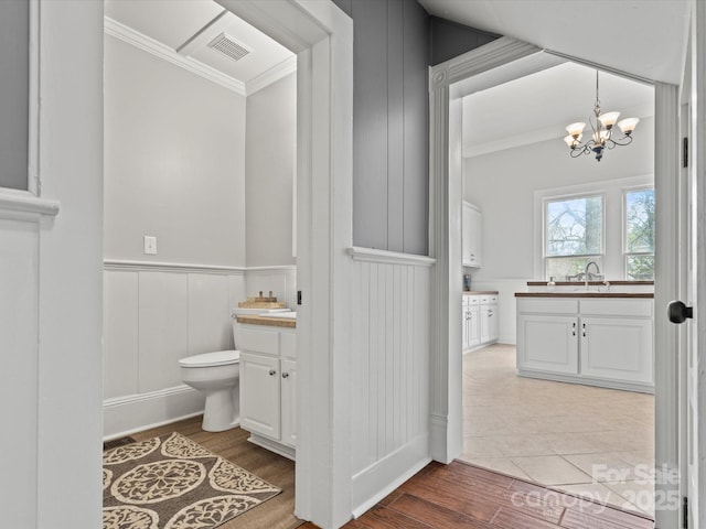 149 Crescent Dr, Chesterfield, SC 29709 - bathroom featuring visible vents, toilet, wood finished floors, vanity, and a notable chandelier