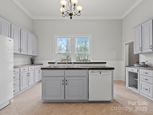 149 Crescent Dr, Chesterfield, SC 29709 - kitchen featuring white appliances, ornamental molding, a sink, dark countertops, and a notable chandelier