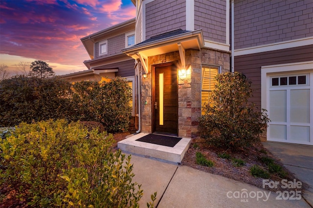 view of exterior entry featuring stone siding