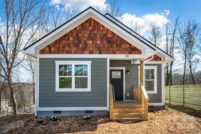 view of front facade with fence and crawl space