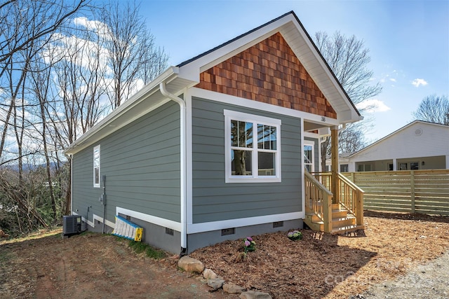 exterior space featuring fence and central AC