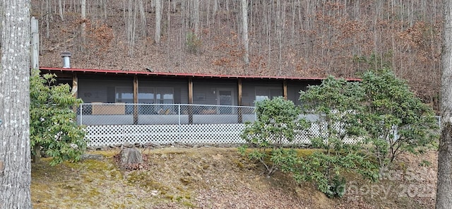 back of property with a sunroom