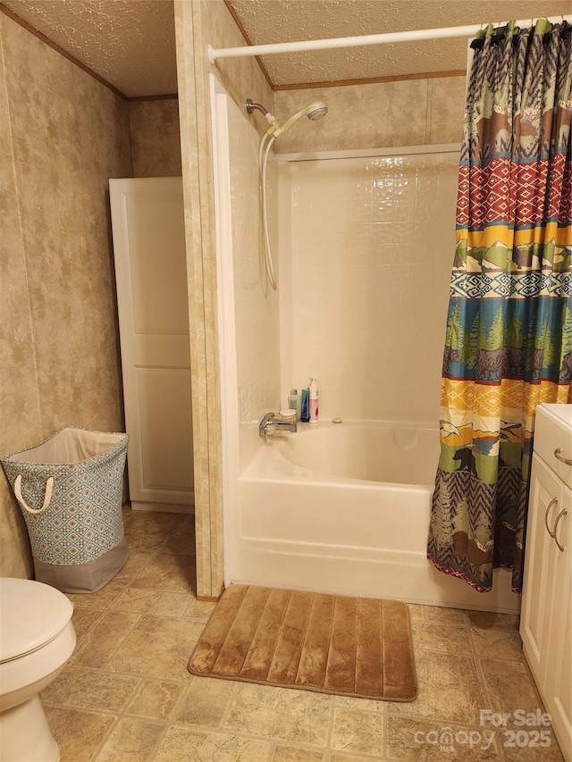 bathroom with toilet, shower / tub combo, and a textured ceiling