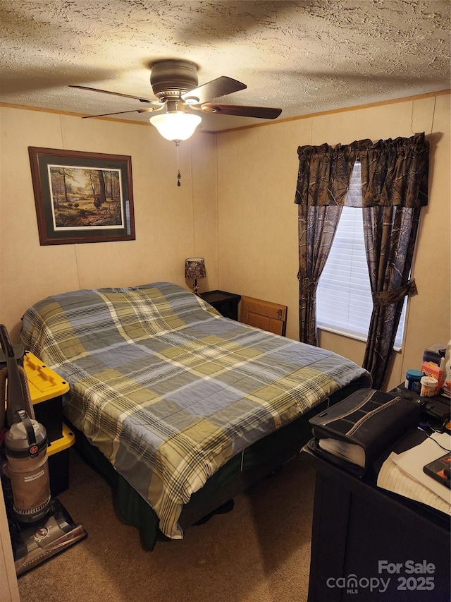 bedroom featuring ceiling fan, carpet flooring, and a textured ceiling