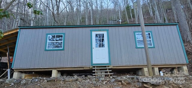 view of outbuilding featuring entry steps and an outbuilding