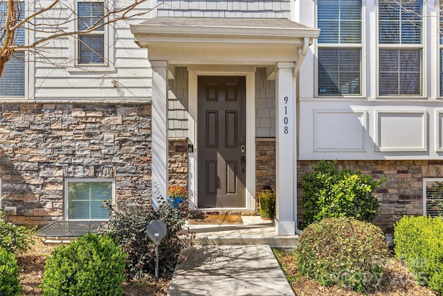 view of exterior entry featuring stone siding