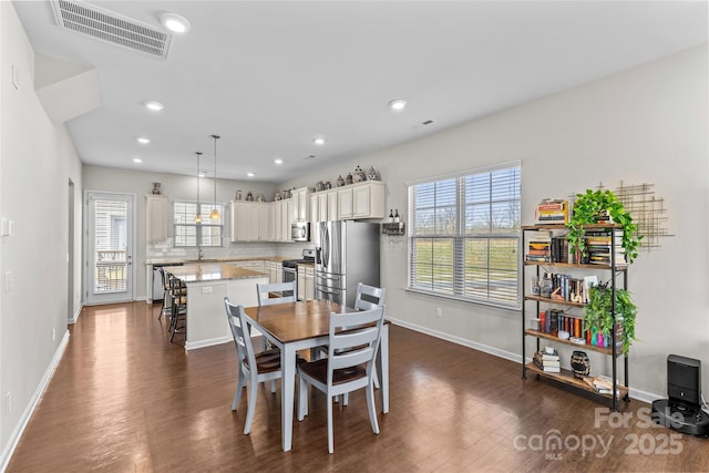 dining area with recessed lighting, baseboards, visible vents, and dark wood-style flooring