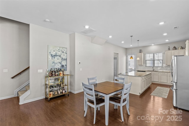 dining space with visible vents, baseboards, dark wood finished floors, stairs, and recessed lighting