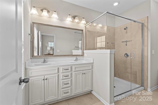 full bathroom with a shower stall, double vanity, tile patterned floors, and a sink