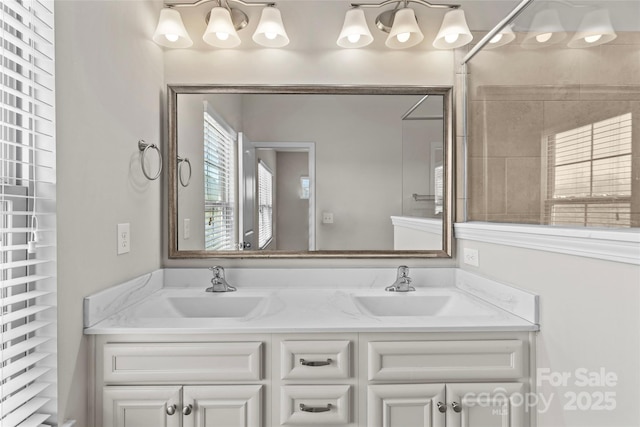 bathroom featuring double vanity and a sink