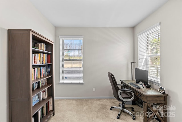 carpeted home office with baseboards