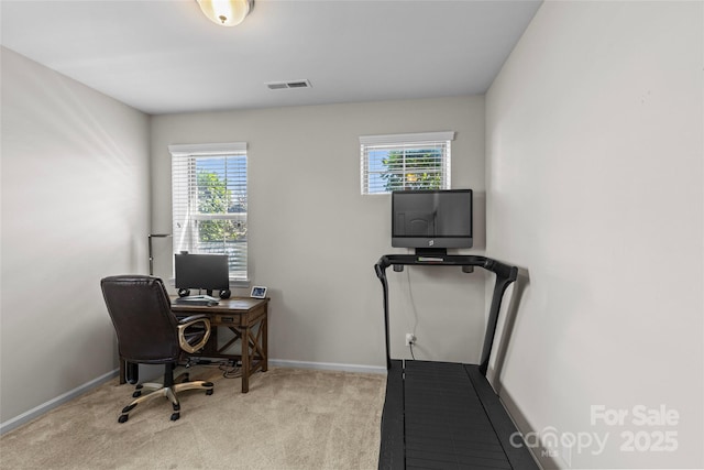 carpeted office space with baseboards and visible vents