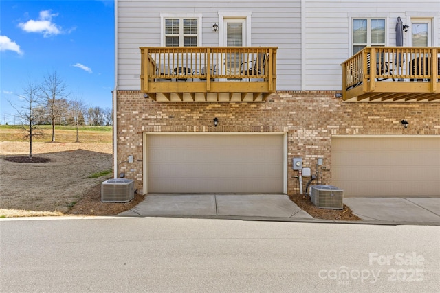 exterior space with central air condition unit and driveway