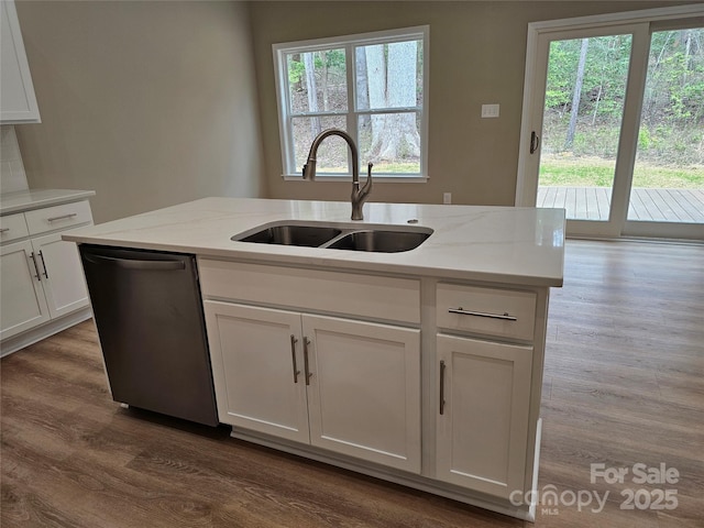 kitchen featuring a sink, wood finished floors, white cabinets, dishwasher, and a healthy amount of sunlight