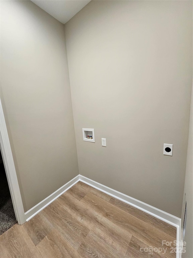 laundry room with electric dryer hookup, washer hookup, wood finished floors, baseboards, and laundry area