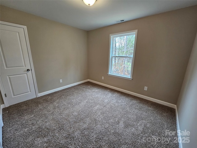 carpeted spare room with baseboards and visible vents