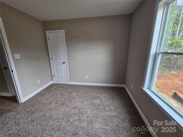 unfurnished bedroom with baseboards and carpet