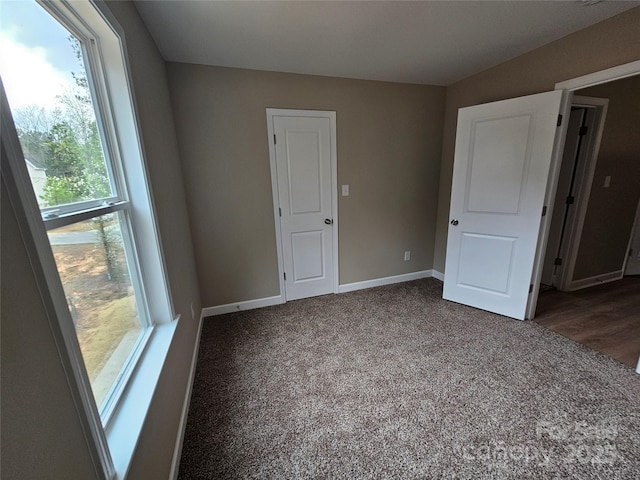 unfurnished bedroom featuring baseboards and carpet floors