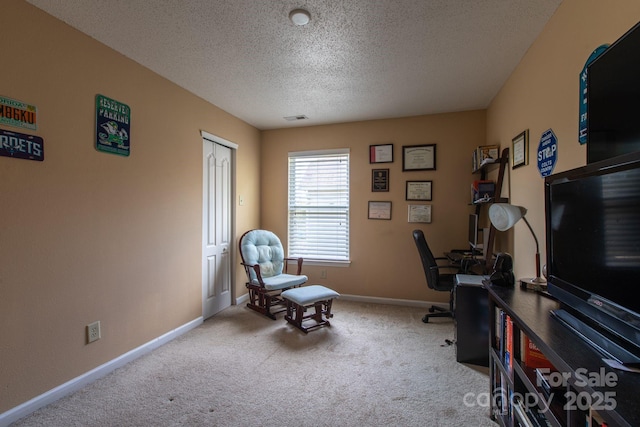 office space with visible vents, baseboards, a textured ceiling, and carpet flooring