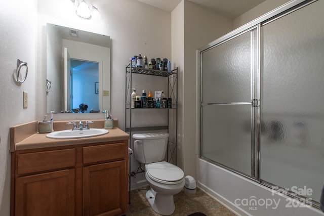 bathroom featuring vanity, toilet, visible vents, and combined bath / shower with glass door