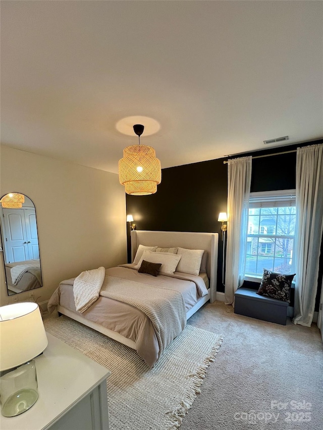 bedroom featuring visible vents and carpet flooring