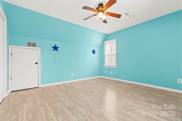 spare room with light wood-style flooring, baseboards, visible vents, and ceiling fan