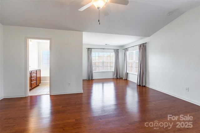 spare room with baseboards, light wood-type flooring, and ceiling fan