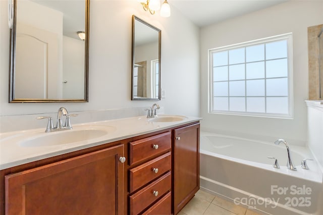 bathroom featuring tile patterned floors, a bath, double vanity, and a sink