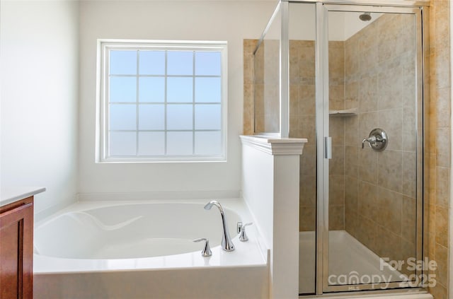 full bathroom featuring a garden tub, a stall shower, and vanity