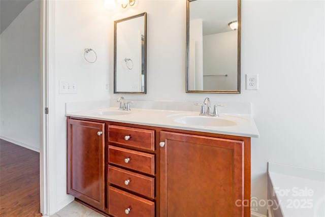 full bathroom featuring double vanity and a sink