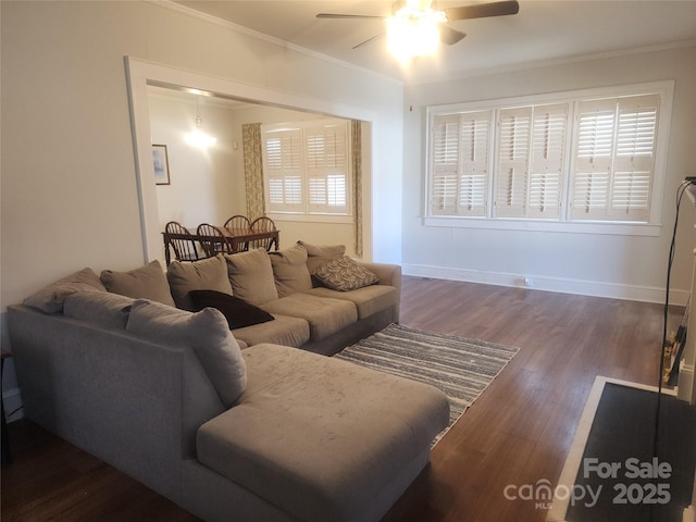 living room with dark wood-style floors, baseboards, ceiling fan, and ornamental molding