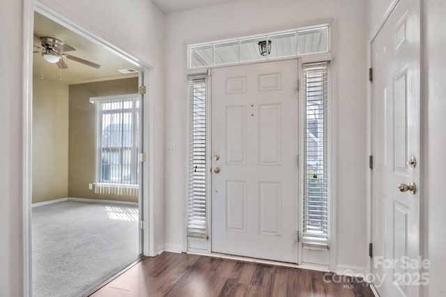 entrance foyer with visible vents, baseboards, a ceiling fan, and dark wood-style flooring