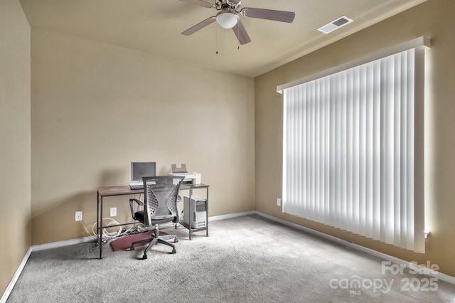 carpeted office space with visible vents, baseboards, and ceiling fan