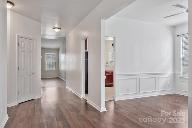 interior space with dark wood-type flooring and a decorative wall